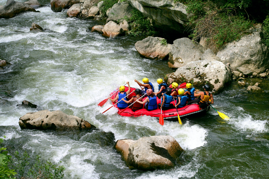 a group of people going white water rafting on a river